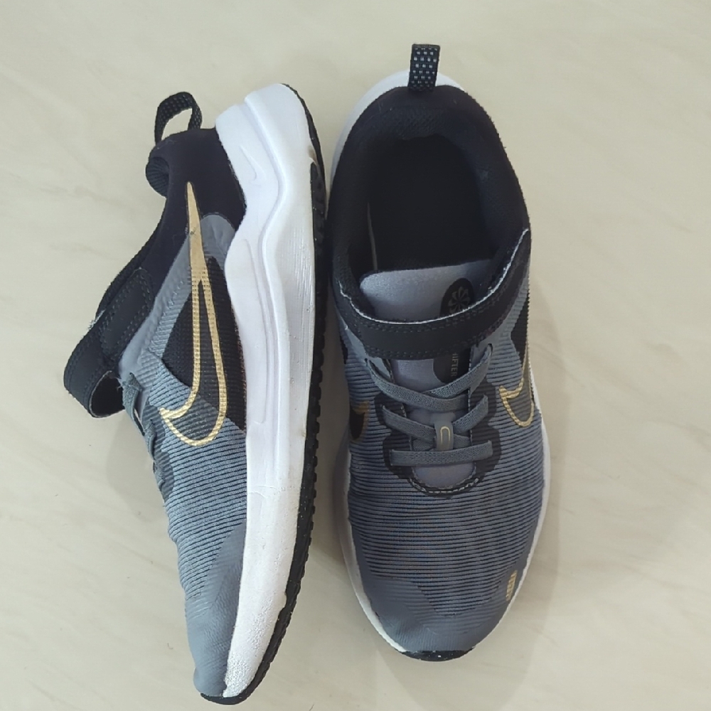 Nike Black and Gold Sneakers with Mesh Upper and Lace-Up Design